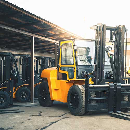 multiple forklifts in a garage