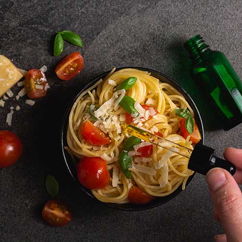 overhead shot on black background of spaghetti made with cbd infused oil