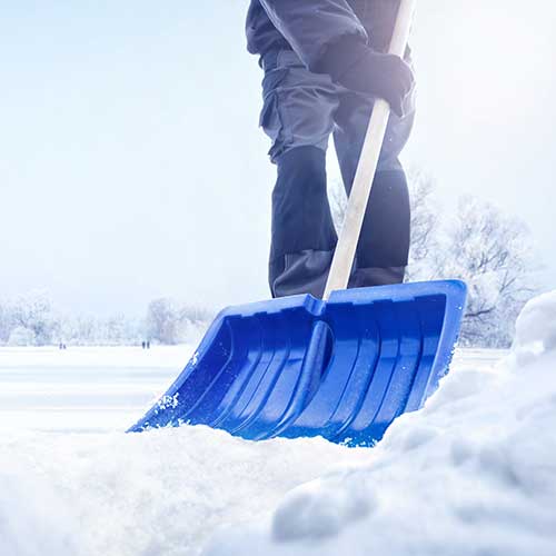 person using a snow shovel in winter