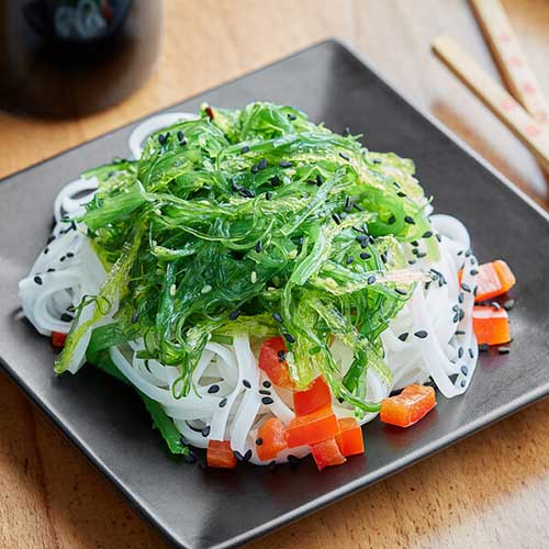 seaweed salad on square black plate