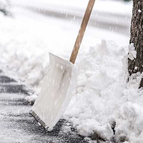 snow shovel standing in the snow