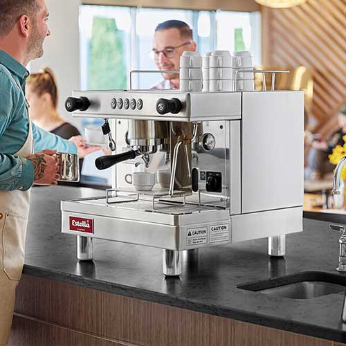 barista making espresso with an estella caffe espresso machine