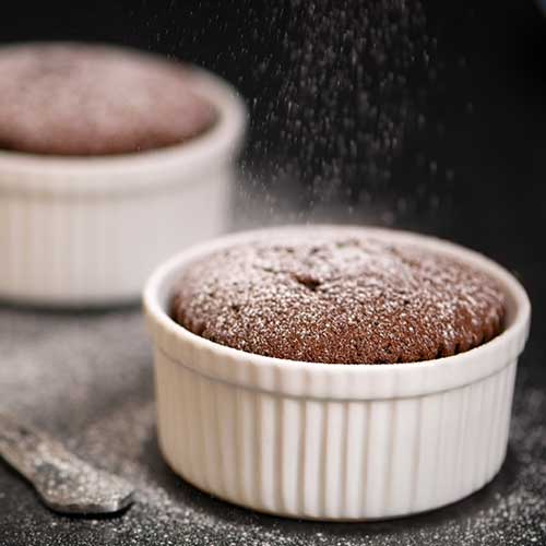 chocolate souffles topped with dusting of powdered sugar