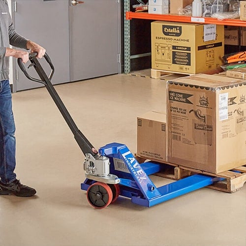 Person operating a pallet jack to lift a pallet of boxes