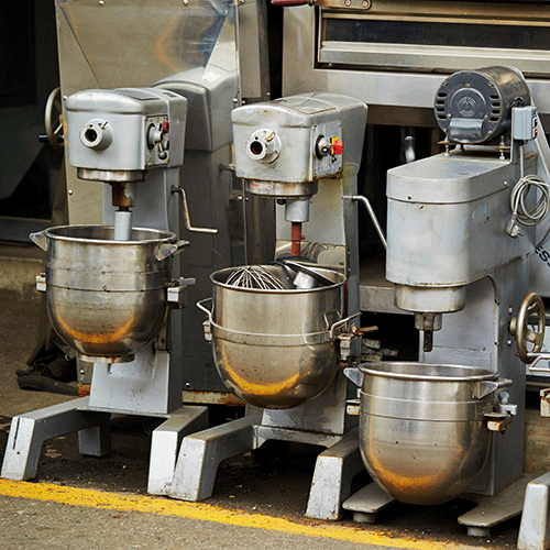four used mixers outside on road