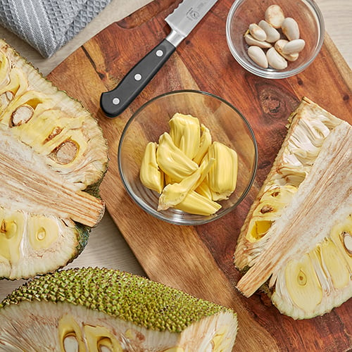 jackfruit on wooden cutting board and in glass bowl