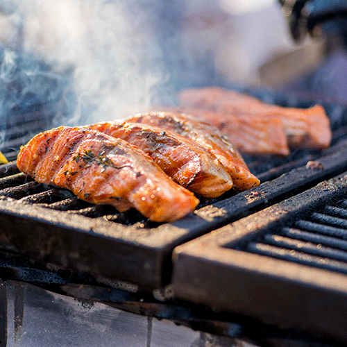 pieces of salmon fried over an open fire