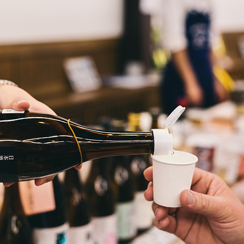 Bottle of sake being served for a sample