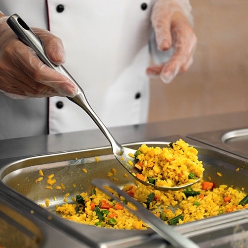 chef serving rice from a food pan