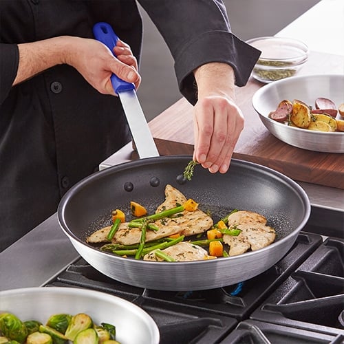 Chef using a non stick pan on stove