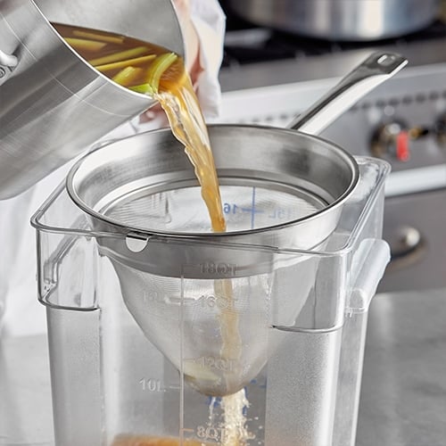 Pouring broth in chinois strainer