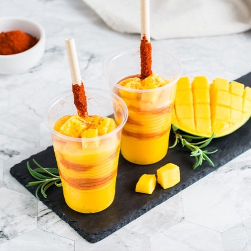 frozen mango drinks with tajin seasoning mixed thoughout