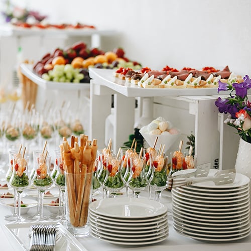 Variety of canapes on an all white buffet table