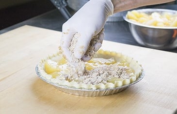 Cover the pie with the crumb crust topping and bake according to your recipe's instructions.