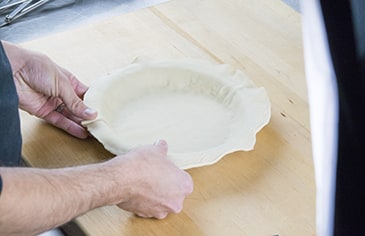 Add your prepared bottom crust to the pie pan.
