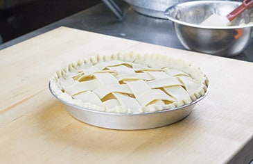 Once the lattice is complete, crimp the bottom and top pie crust edges together and bake according to your recipe's instructions.