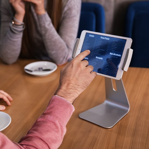 man using a table computer menu on the table in a restaurant