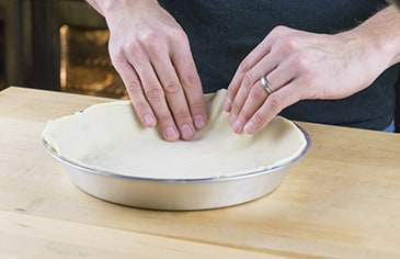 Add your prepared bottom crust to the pie pan.