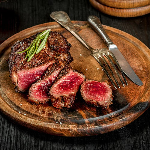 Grilled juicy filet mignon steak with salt pepper and rosemary