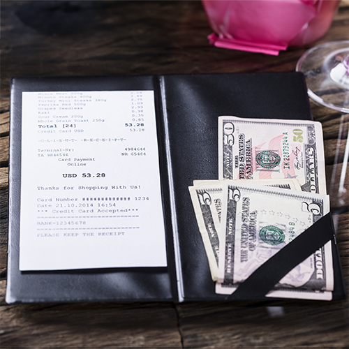 a billfold with a receipt and several bills
