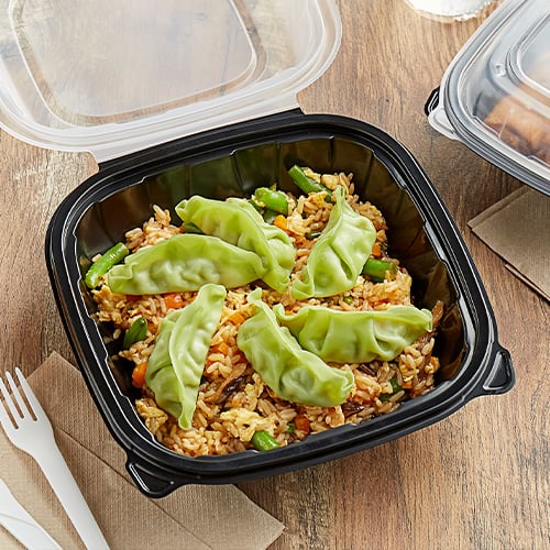 fried rice and green dumplings in a takeout container