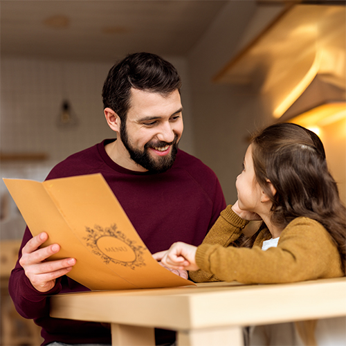 parent reading a kids menu with child