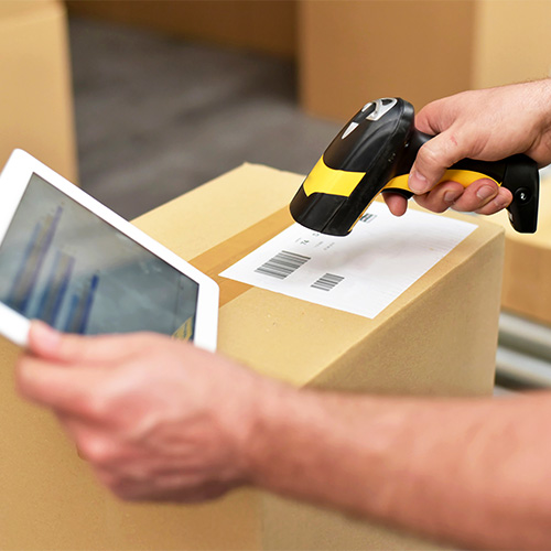 worker in the warehouse scanning parcels for retail and transport shipping