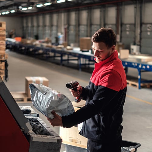 warehouse employee scanning barcode on package