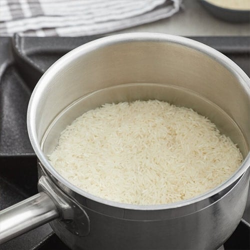 Large pot full of rice on a stovetop