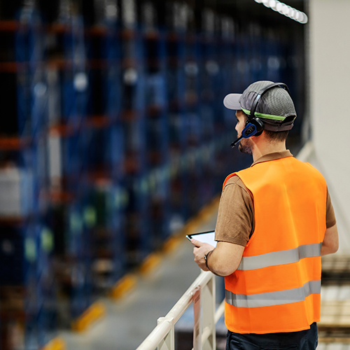 employee using headset to locate packages in warehouse