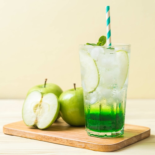 Apple Mojito Drink sitting next to apples