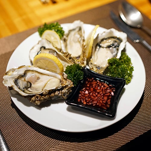oysters on a plate with mignonette