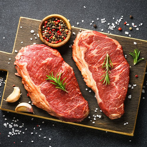 raw choice beef steaks with pepper
