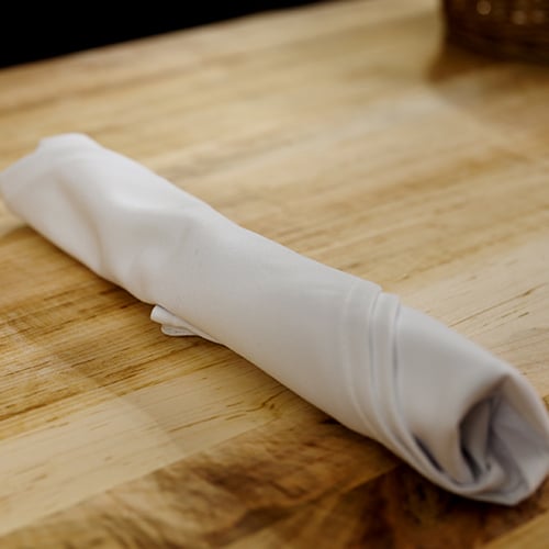 silverware rolled into a white cloth napkin