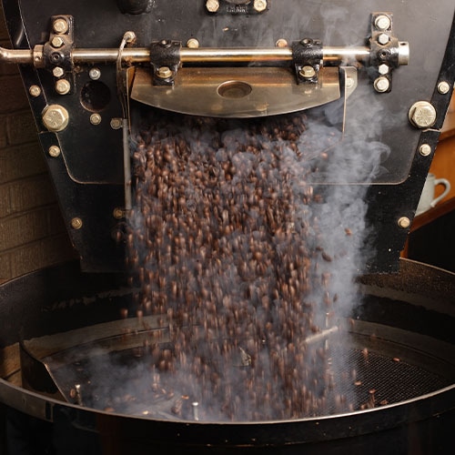 Coffee Roaster Machine dispensing freshly roasted beans