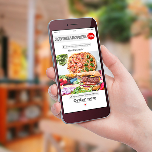 Hand holding smartphone with food ordering website pulled up