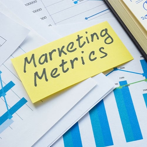 Marketing metrics paper on other stacks of paper