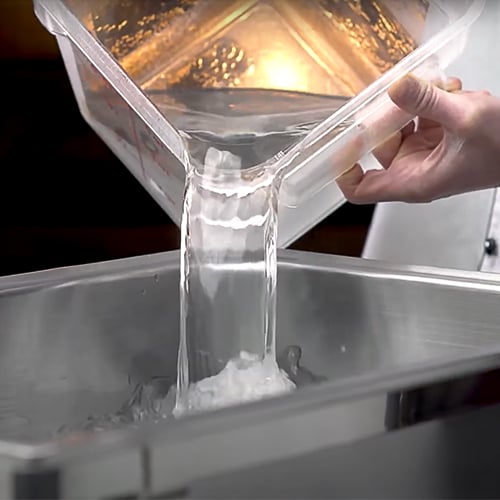 pouring hot water into a food pan