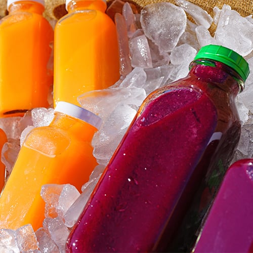 Cold Pressed juice bottles laying in ice