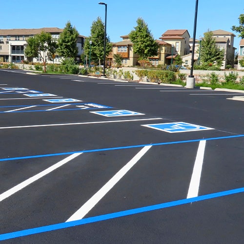 Freshly resurfaced and repainted handicap parking space in a parking lot