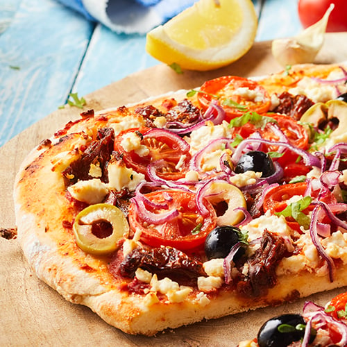 Greek pizza with olives, tomatoes, onions