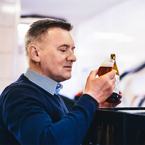 man tasting a craft beer from brewery