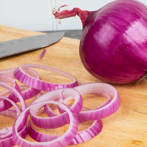 Red Onions with sliced rings next to it