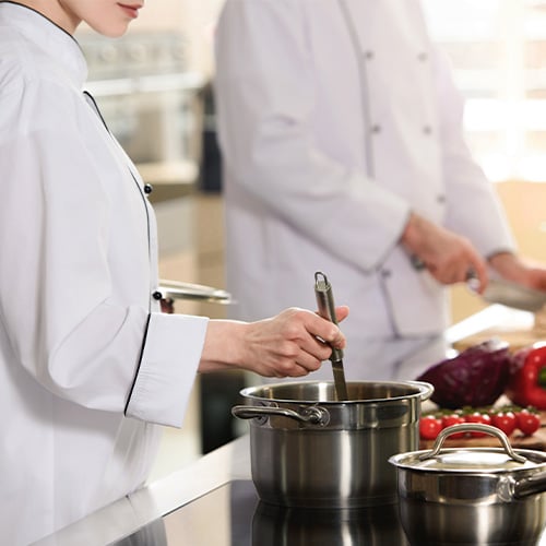 Professional team of cooks working together in a modern kitchen