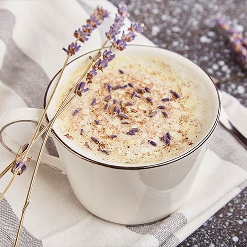 stylish aesthetic lavender coffee with flowers close up