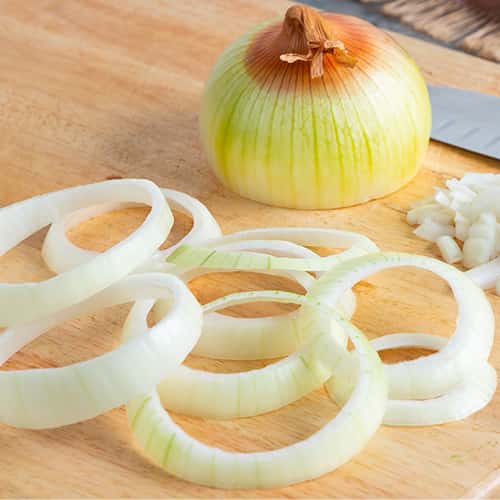 Yellow Onions on a Cutting board