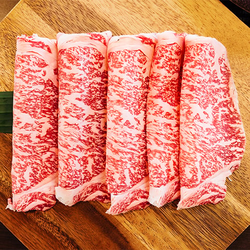closeup of slices of raw wagyu steak on a table
