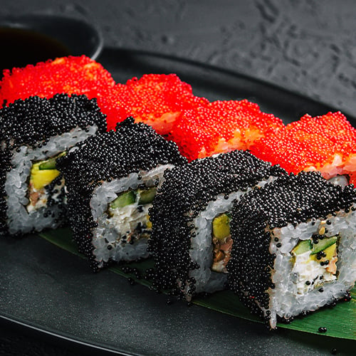 two california sushi rolls with tobiko and masago on the outside