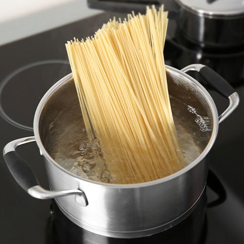 Noodles in boiling water on stovetop