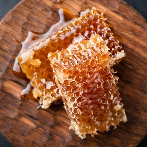 Top view of honeycomb pieces on a circular block of wood